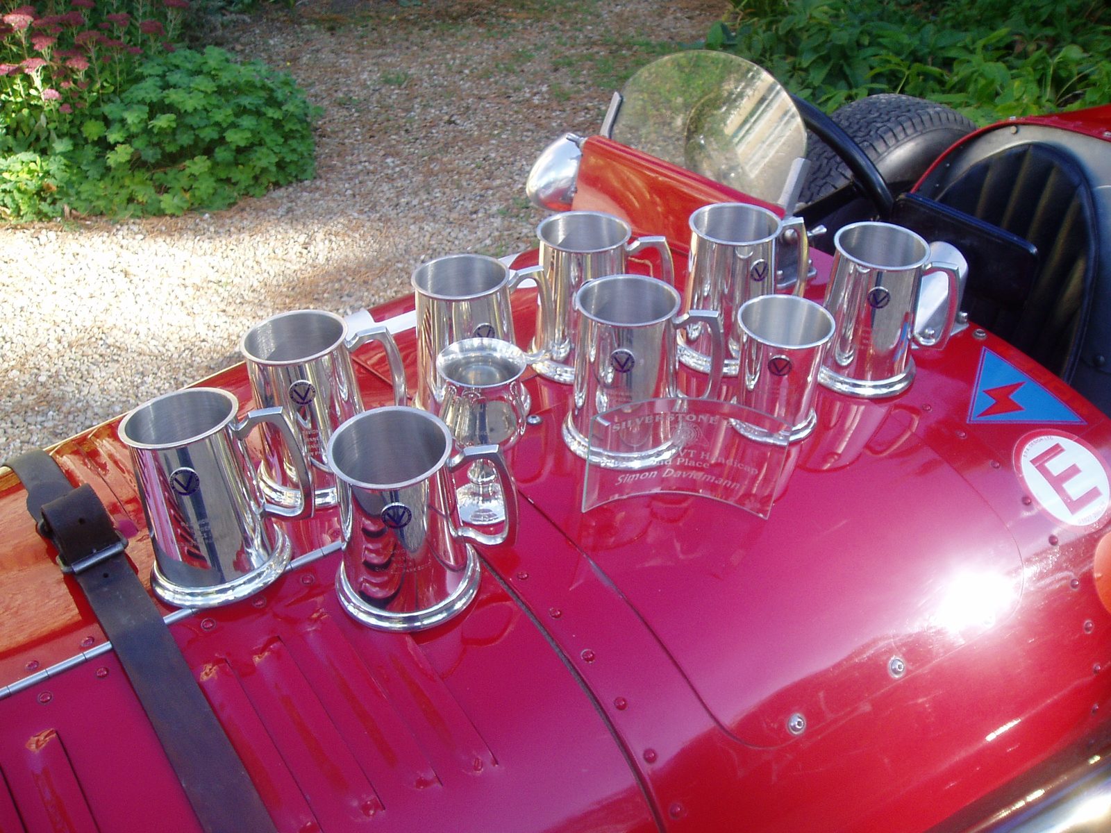 Silver tankards lined up on the red Riley